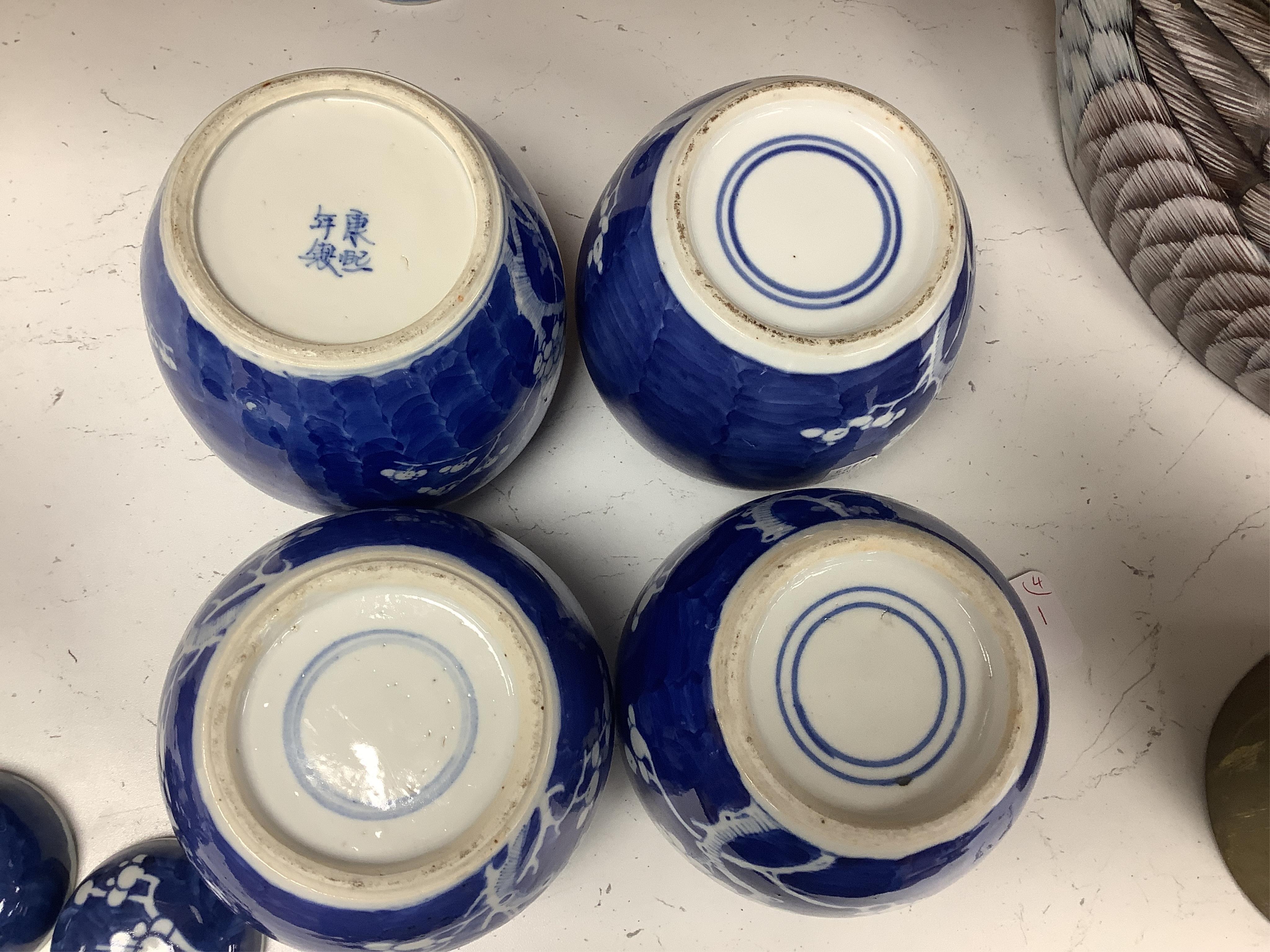 Four Chinese blue and white prunus jars and covers, tallest 15cm high. Condition - good